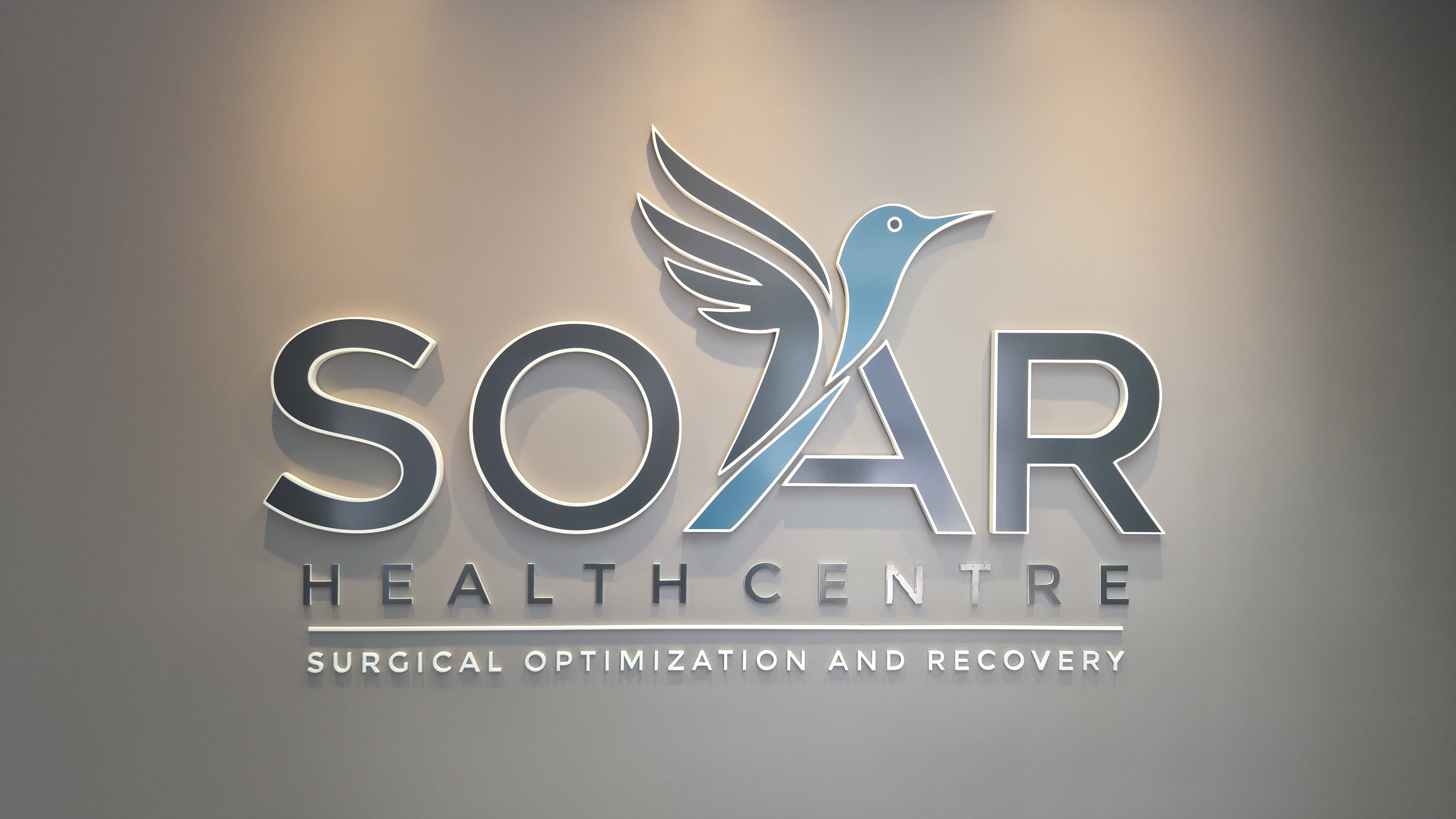 SOAR Health Centre reception with three-dimensional wall logo