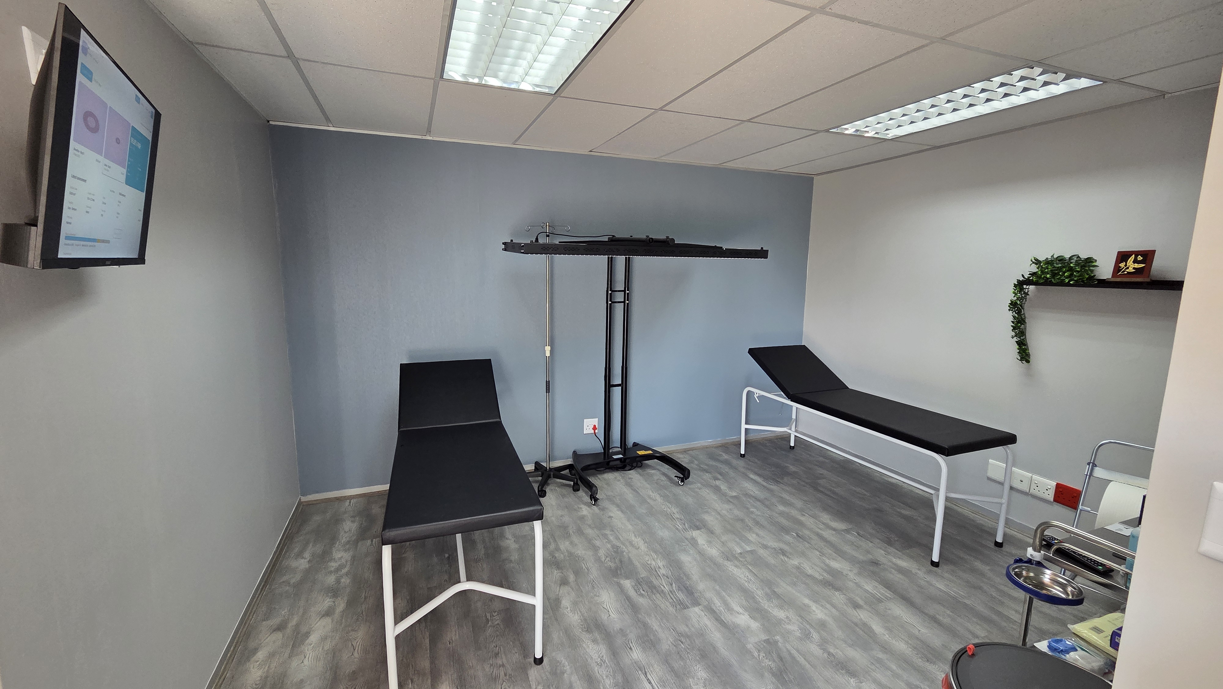 SOAR Health Centre treatment room with two treatment couches and overhead photobiomodulation array