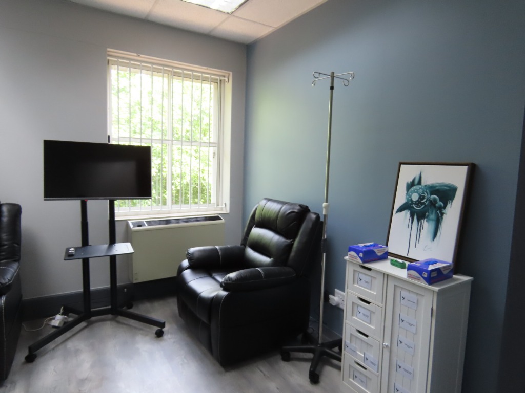 Private SOAR infusion suite with reclining treatment chair and IV stand